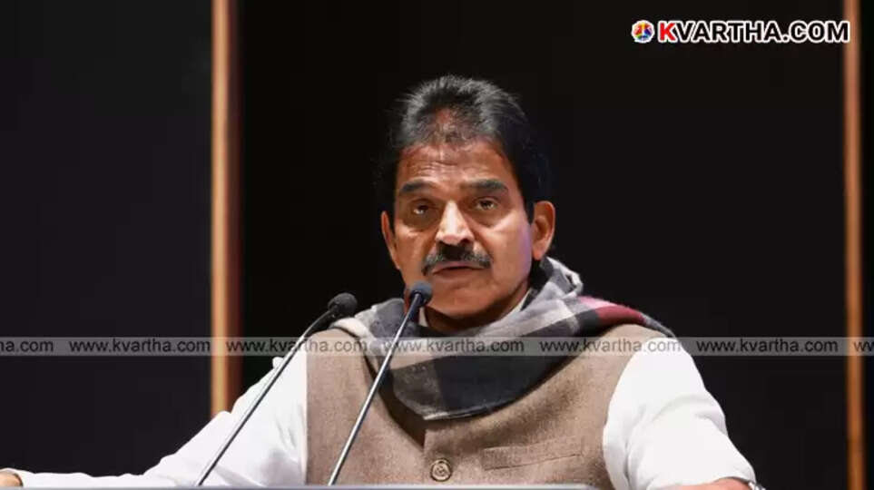KC Venugopal listening to farmers in a paddy field in Palakkad.