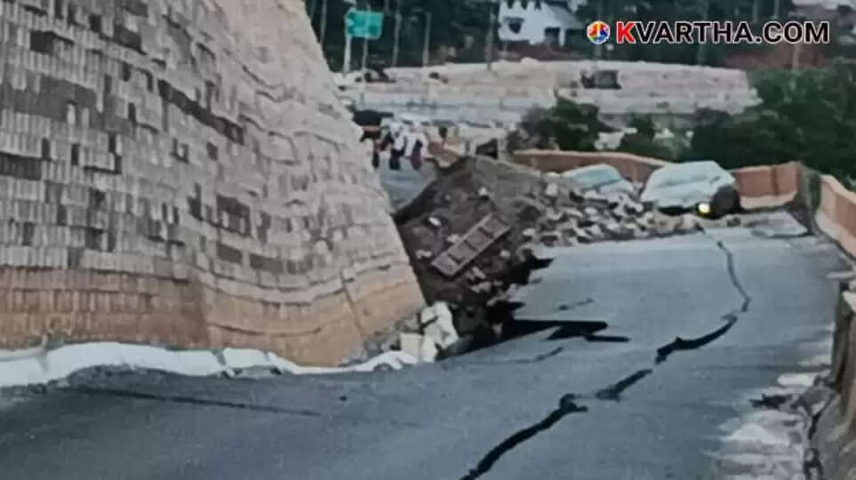 Image of a collapsed section of a road with visible damage and construction debris.