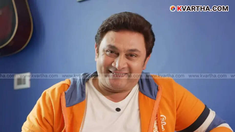 Bollywood actor Rajesh Kumar in a candid pose, smiling.