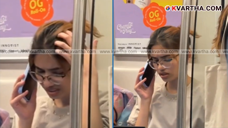 Woman working on a laptop inside a crowded Delhi Metro train.