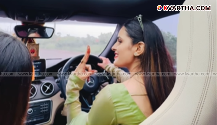 A still image from Nikki Bhati's viral video showing her smiling while driving a car.