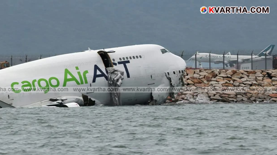 Cargo plane partially submerged in water after skidding off runway in Hong Kong.