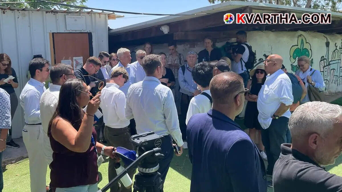 Foreign diplomats talking with Palestinian residents in the village of Khan al-Ahmar