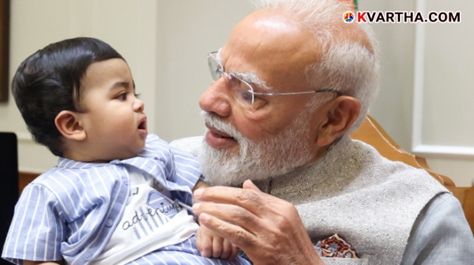 PM Narendra Modi holding Neeom Aswin Krishna, grandson of actor Krishnakumar at 7 LKM.