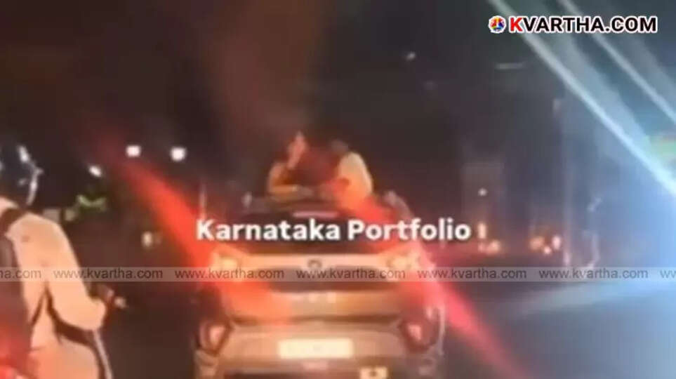 Couple kissing on the sunroof of a moving car in Bengaluru.