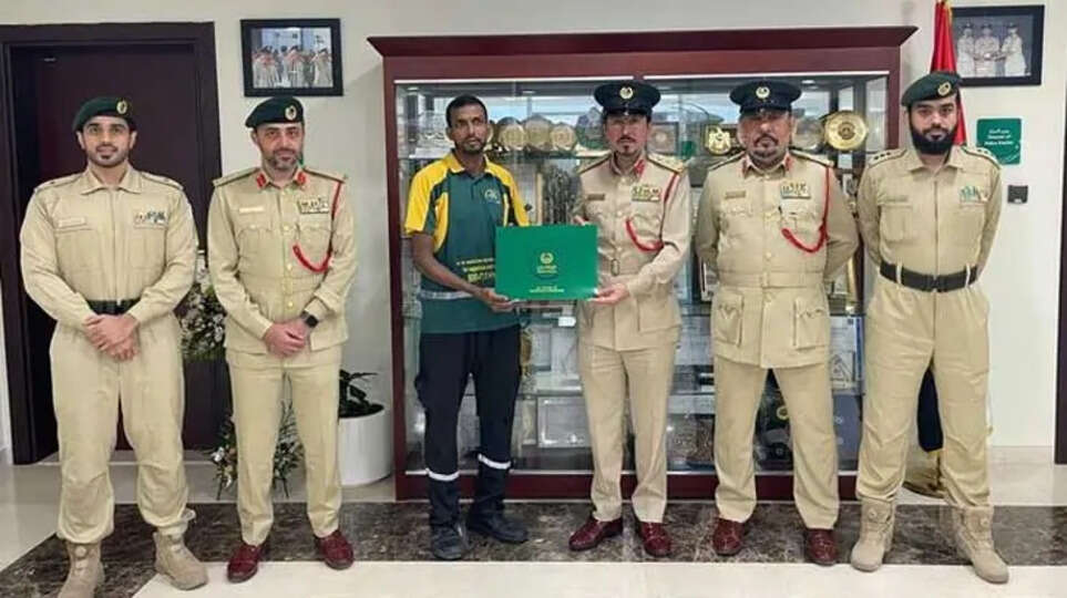 An Indian expat being honored by the Dubai Police for returning lost money.