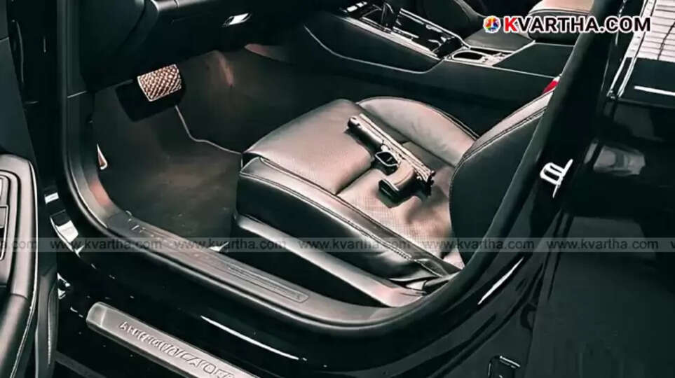 A Delhi registered car parked by the roadside in Vadakara with a suspected gun inside, surrounded by police.