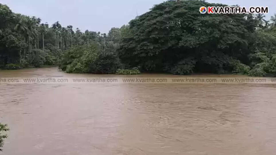 A car partially submerged in a fast-flowing river, with murky water visible around it, depicting a river accident scene.