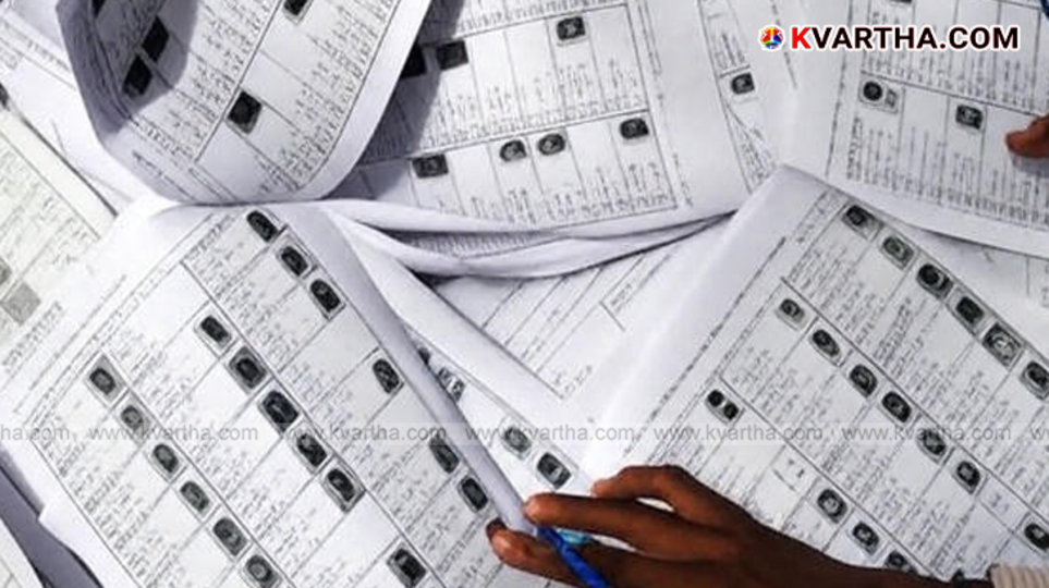 A person checking the voter list on a register.