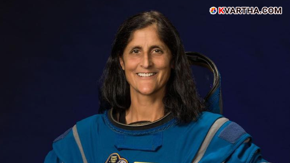  Sunita Williams in her NASA spacesuit smiling.
