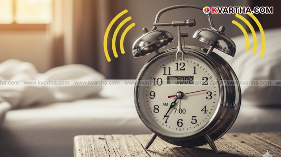 A person's hand pressing the snooze button on an alarm clock.