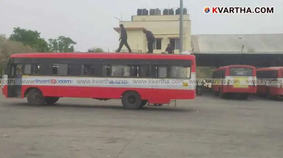 Karnataka RTC bus traveling on a road.