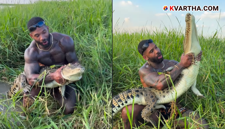 Man holding a large crocodile in a viral video.