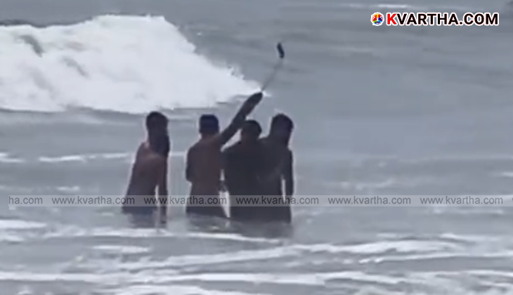 Lifeguards rescue youths from rough seas at Payyambalam beach, Kerala.