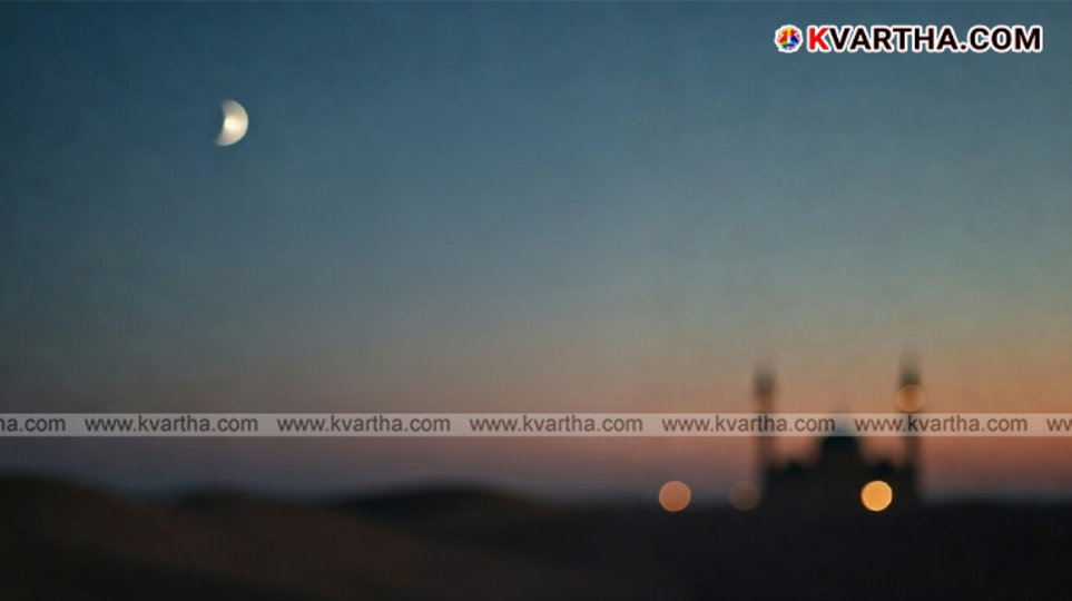 Crescent moon in the night sky over a Saudi Arabian cityscape.