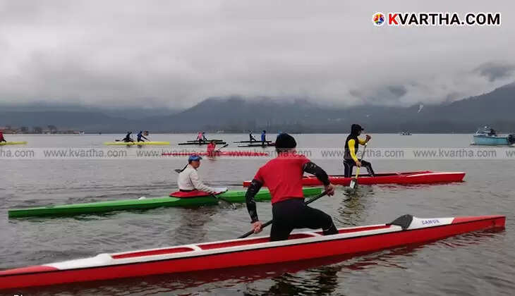 A person kayaking on a calm water body.