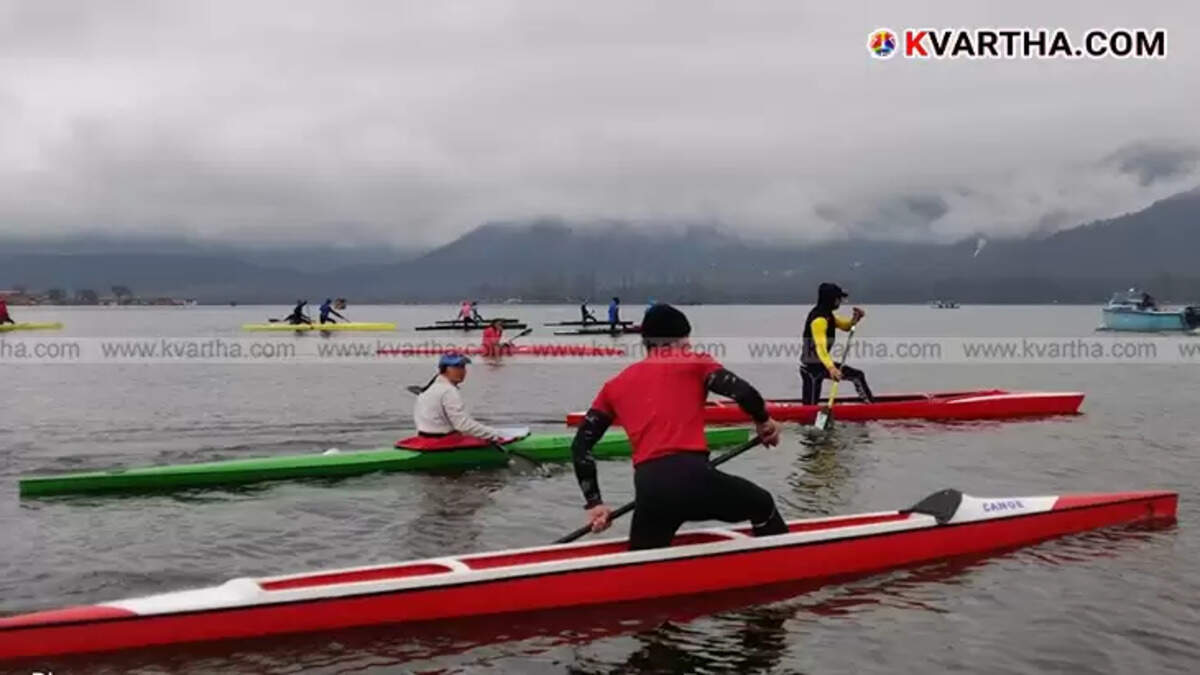 A person kayaking on a calm water body.