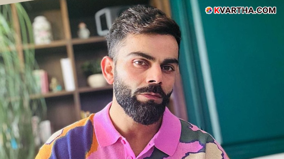 Virat Kohli looking at his mobile phone.