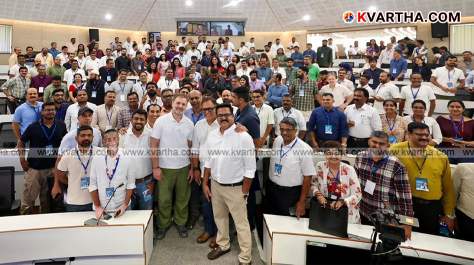 Rahul Gandhi standing on a stage interacting with a crowd of IT professionals at Technopark