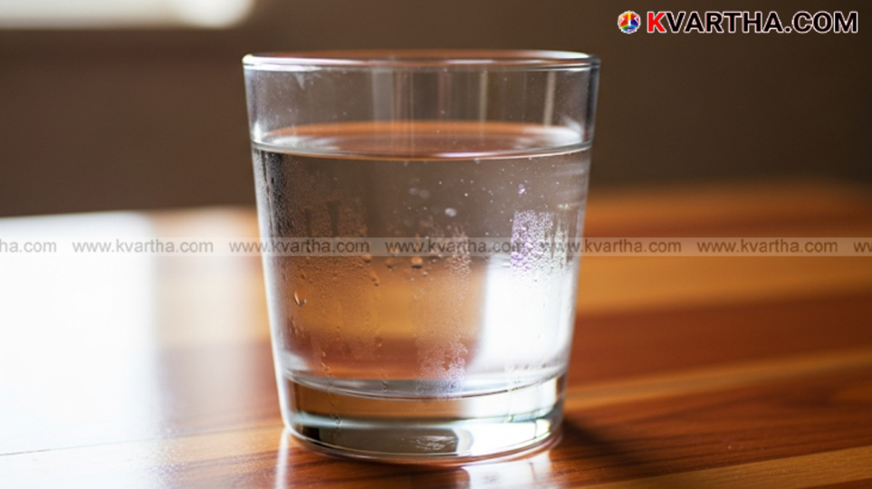 A glass of water with an apple.
