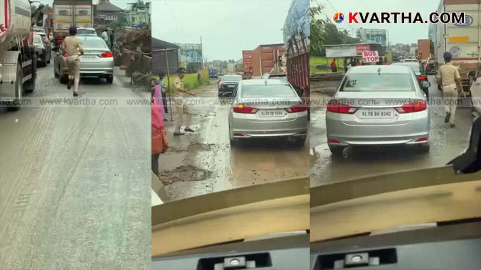 Kerala Police officer clearing path for ambulance in heavy traffic.