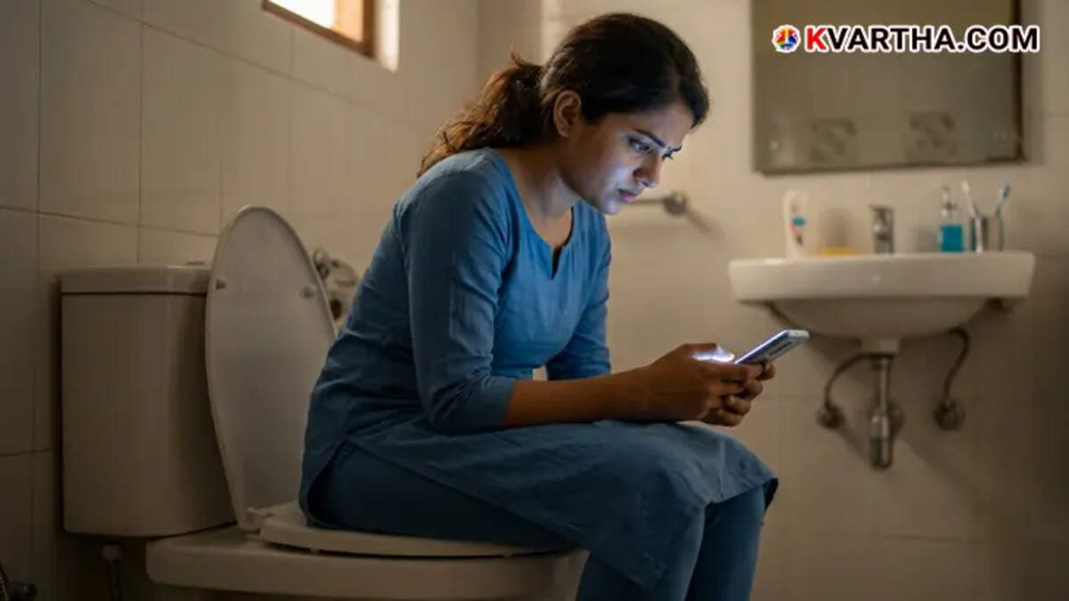 A person using a smartphone while sitting in a toilet
