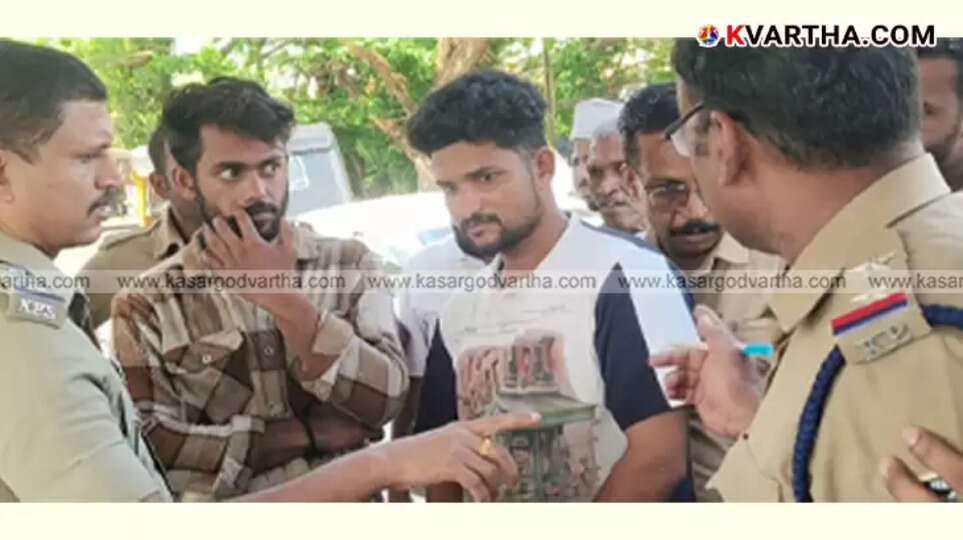 Police displaying seized Hashish oil in Payyanur after arresting two suspects.