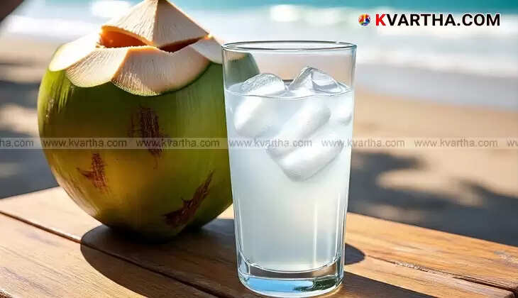 A glass of fresh tender coconut water with coconut pieces.