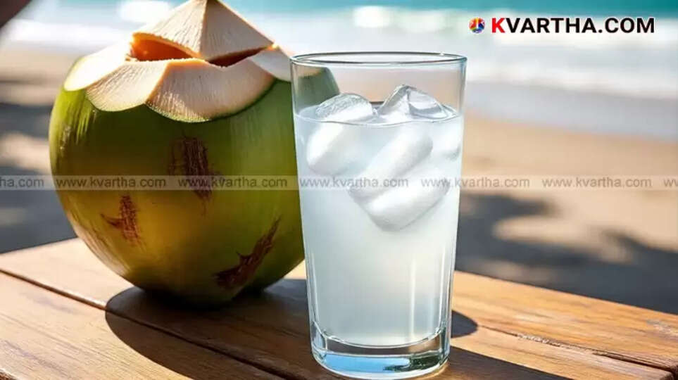 A glass of fresh tender coconut water with coconut pieces.
