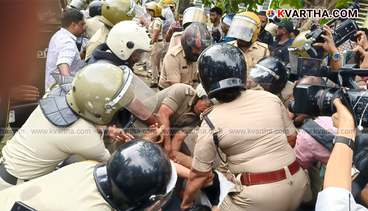 KSU activists protesting against police, being hit by water cannon.