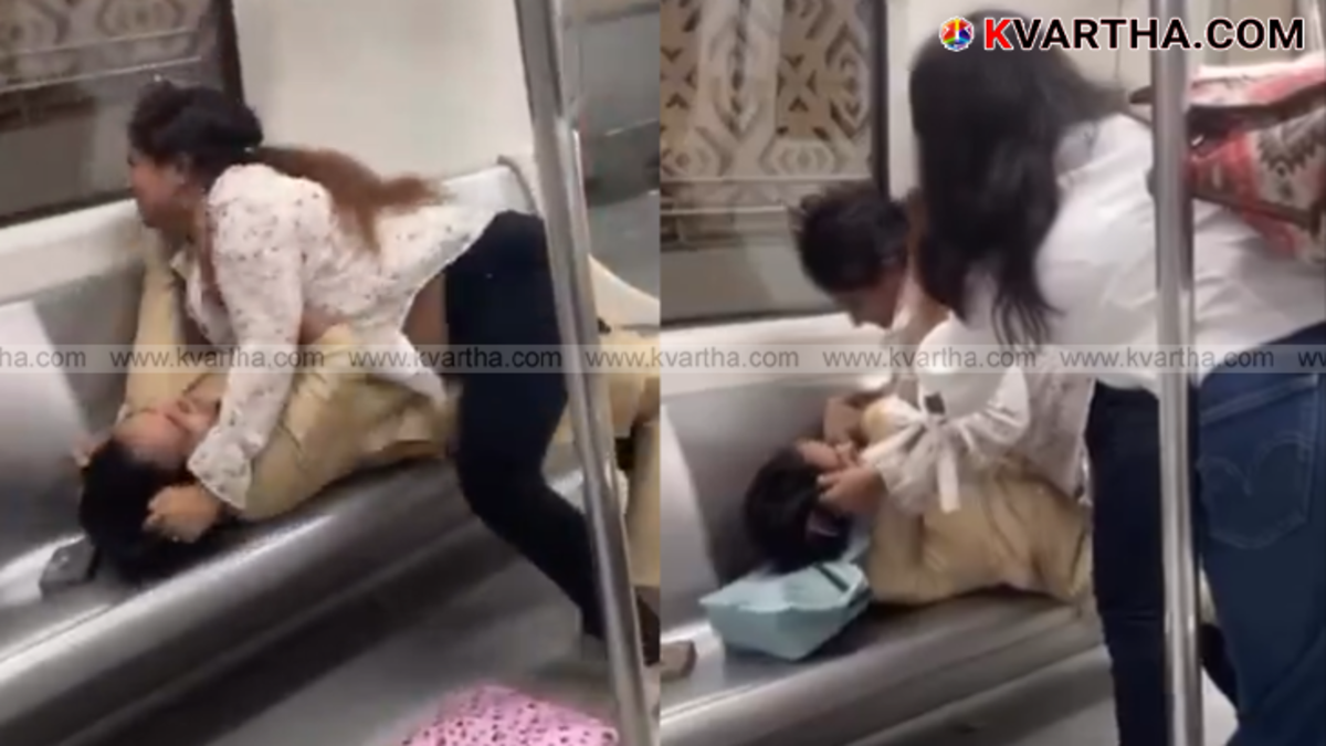 Two women fighting inside a crowded Delhi Metro train.