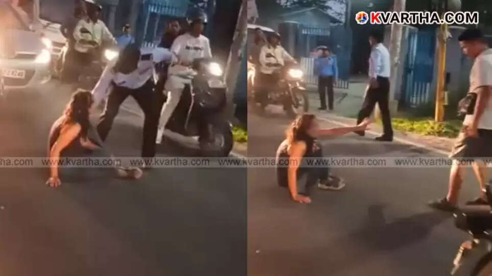 Woman sitting on Dehradun road, causing traffic disruption, viral video.
