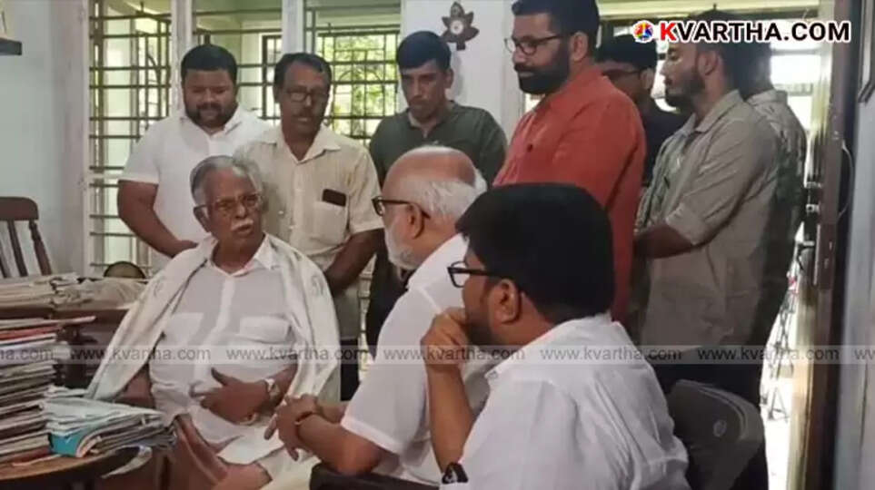 M.A. Baby honoring T. Padmanabhan with a shawl.