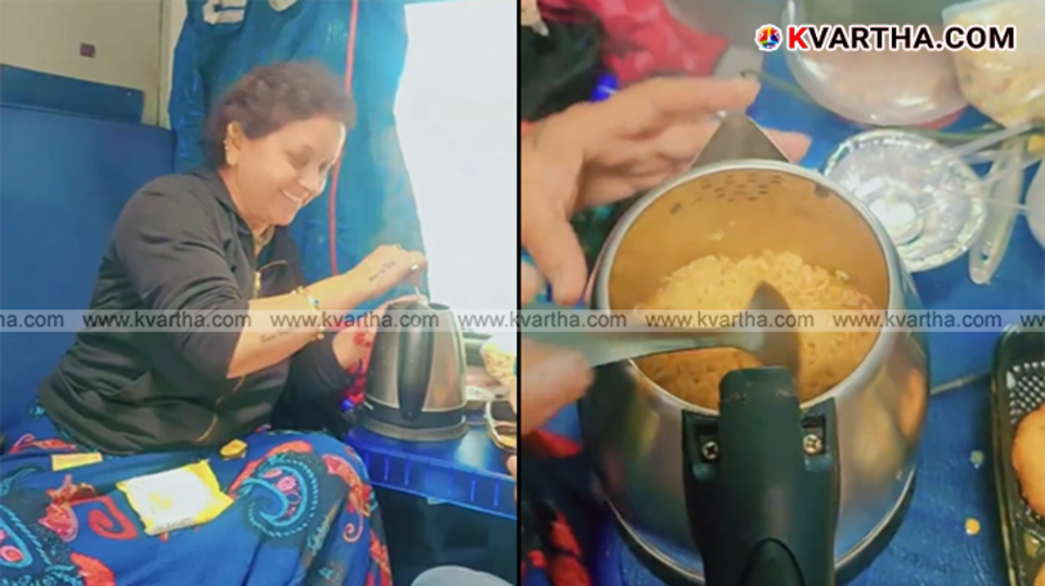 Passenger using an electric kettle near a power socket in a train coach.