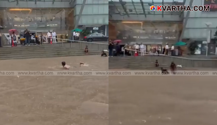A video grab showing a teenager swimming in a waterlogged street in Mumbai.