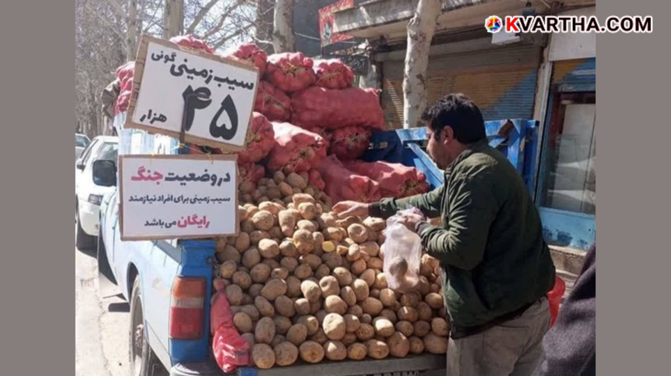 A Persian vendor's pickup truck filled with potatoes and a handwritten sign in Farsi