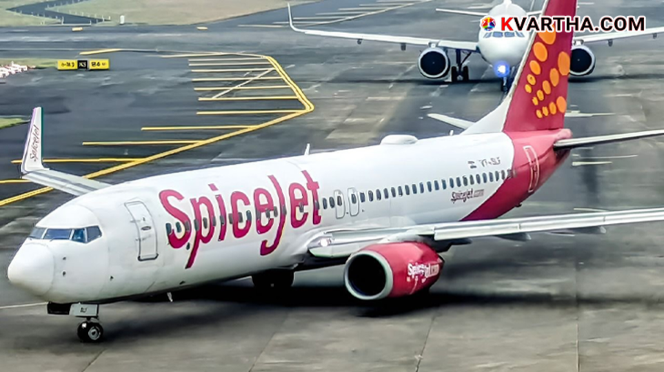 A SpiceJet airplane parked safely at the airport tarmac.