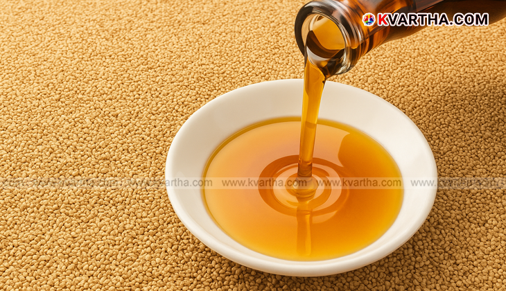 A bottle of til oil with sesame seeds on a table.