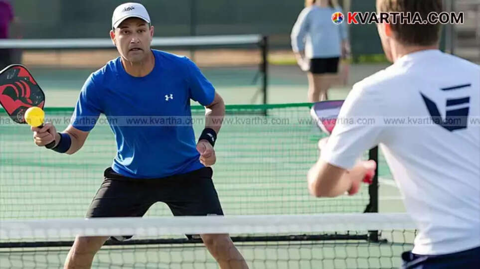 Pickleball being played in a small court with paddles
