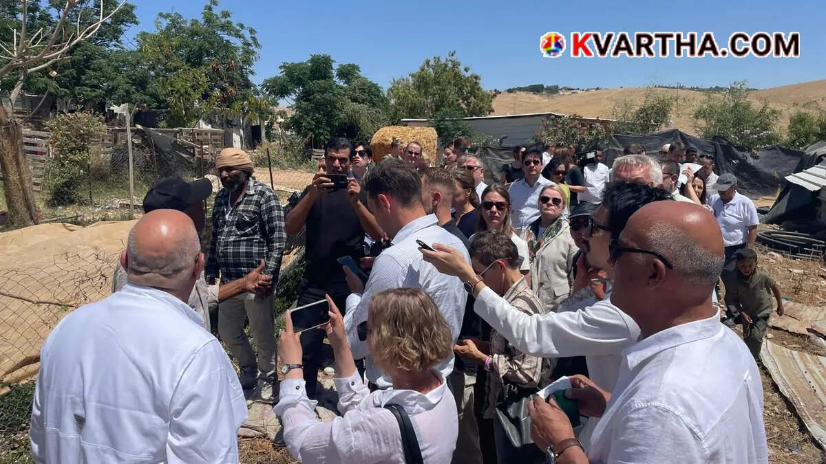 Foreign diplomats talking with Palestinian residents in the village of Khan al-Ahmar