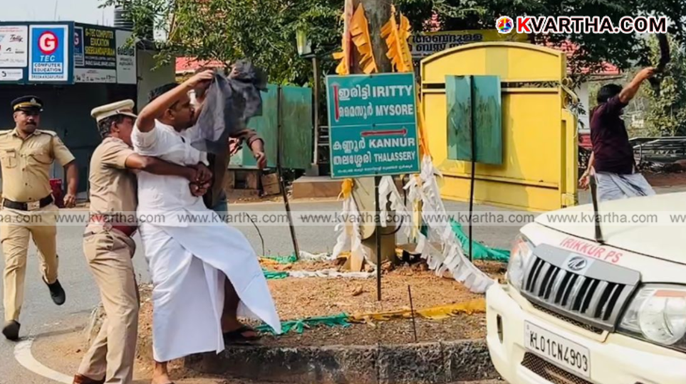 Youth Congress activists protesting with black flags on the road.