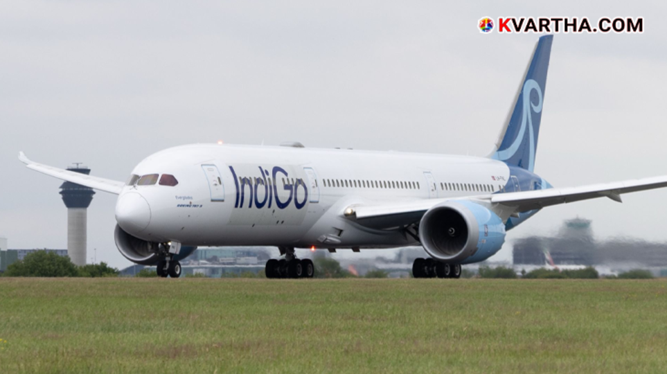 An IndiGo flight plane on the runway at an airport.