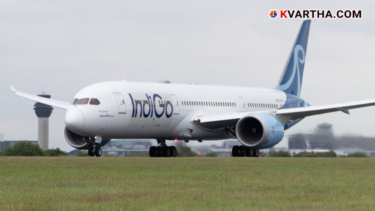An IndiGo flight plane on the runway at an airport.