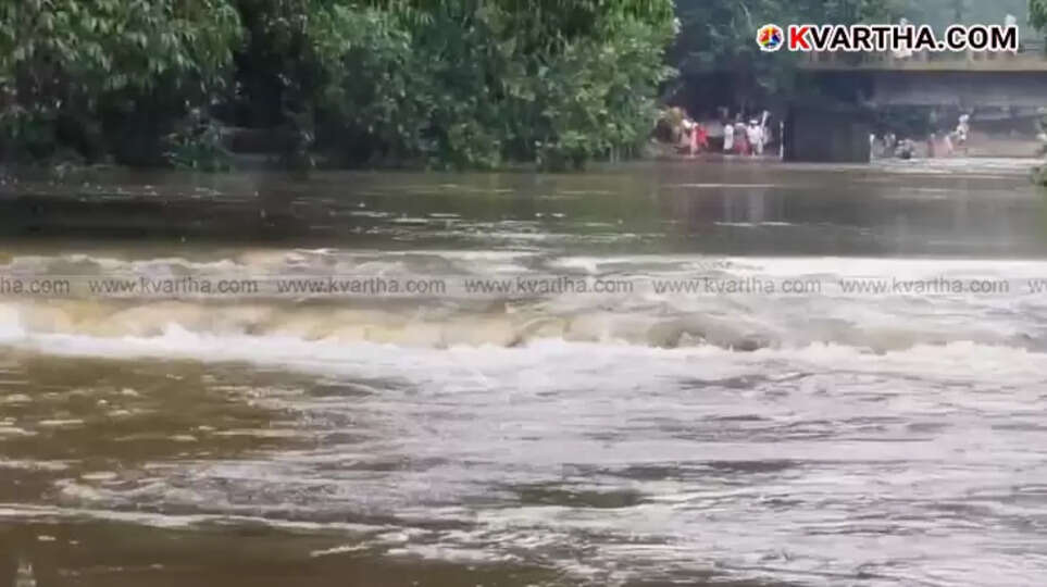 Fire and Rescue Services personnel conducting a search operation in the Kottiyoor river for missing youths.