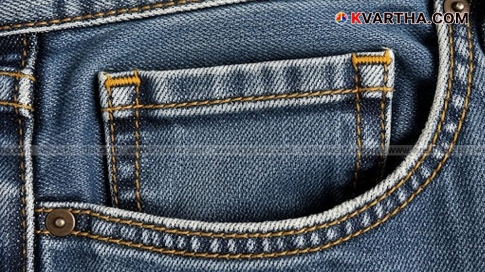 Close-up of the small fifth pocket on a pair of blue jeans.