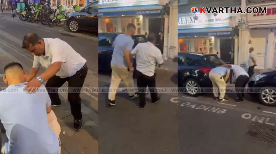 Foreigner struggling after eating London's hottest curry, sitting on roadside.