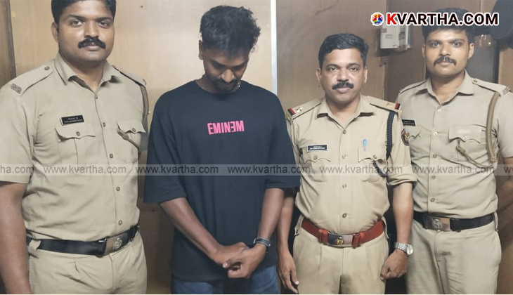 Excise officer holding a packet of hashish oil near a checkpost.
