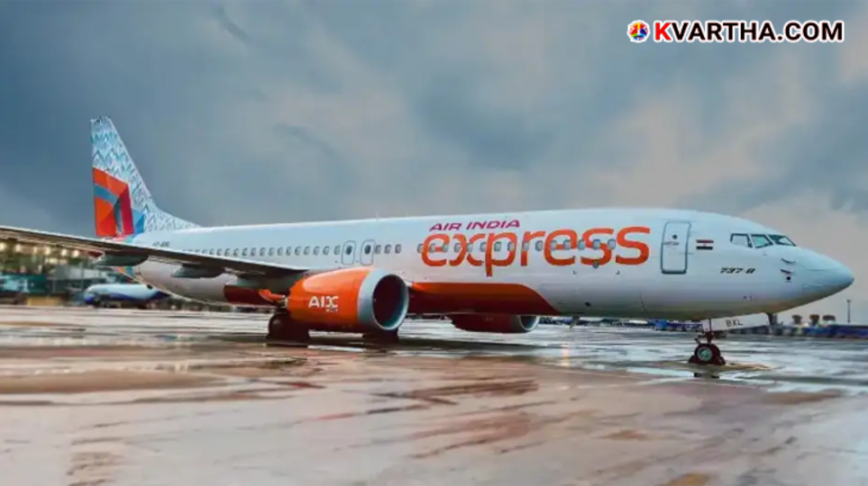 An Air India Express plane at a terminal with the word Cancelled on the flight board