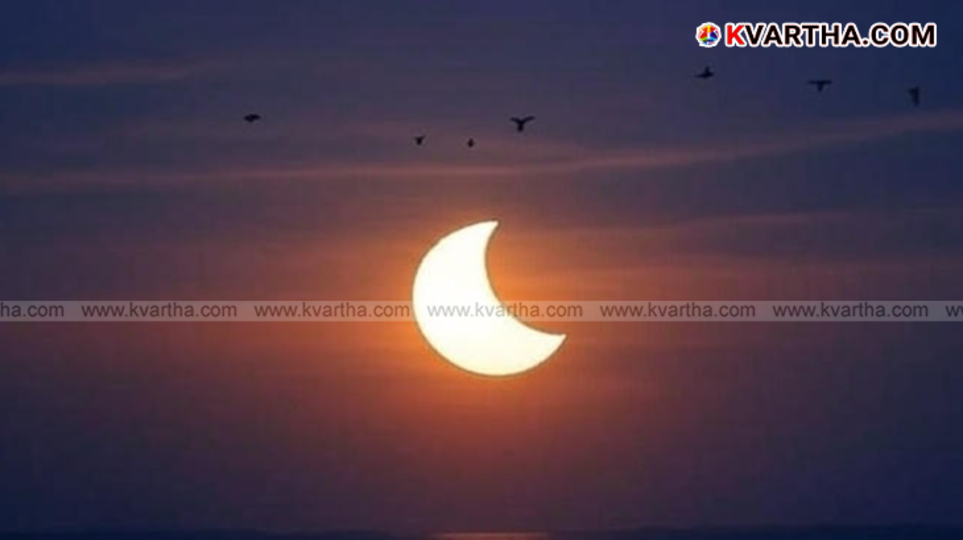 A partial solar eclipse as the moon passes in front of the sun.