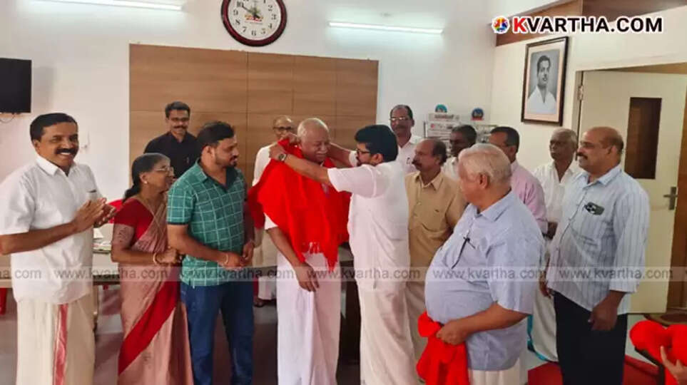 K.V. Raveendran, a former Congress leader, being welcomed into the CPI(M) by party leaders in Kannur.